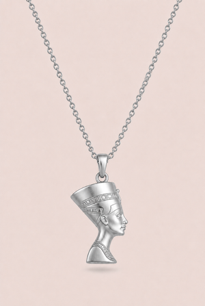 Silver necklace with a pendant of a woman's face on a beige background